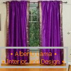 Стая с пурпурни завеси на прозореца