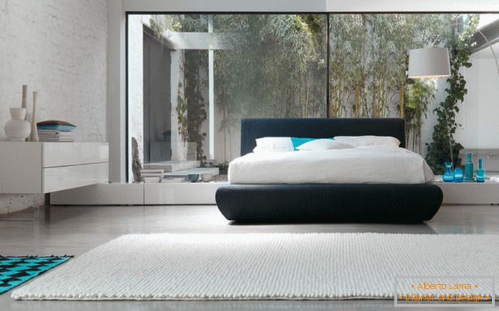 Для оформления уютной спальни хай-тек использовано минимум мебели. В началото на композицията има ниско легло.