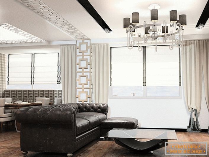 Обзавеждането в стила на арт деко е винаги големи мебели. Идеален за декориране на всекидневната в тази стилистична концепция е коженият диван с памучна материя.
