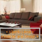 Кафяв диван и червено фотьойл в хола